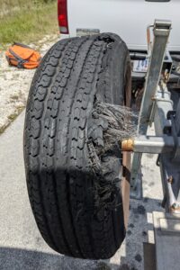 Up-close photo of a damage car tire. 