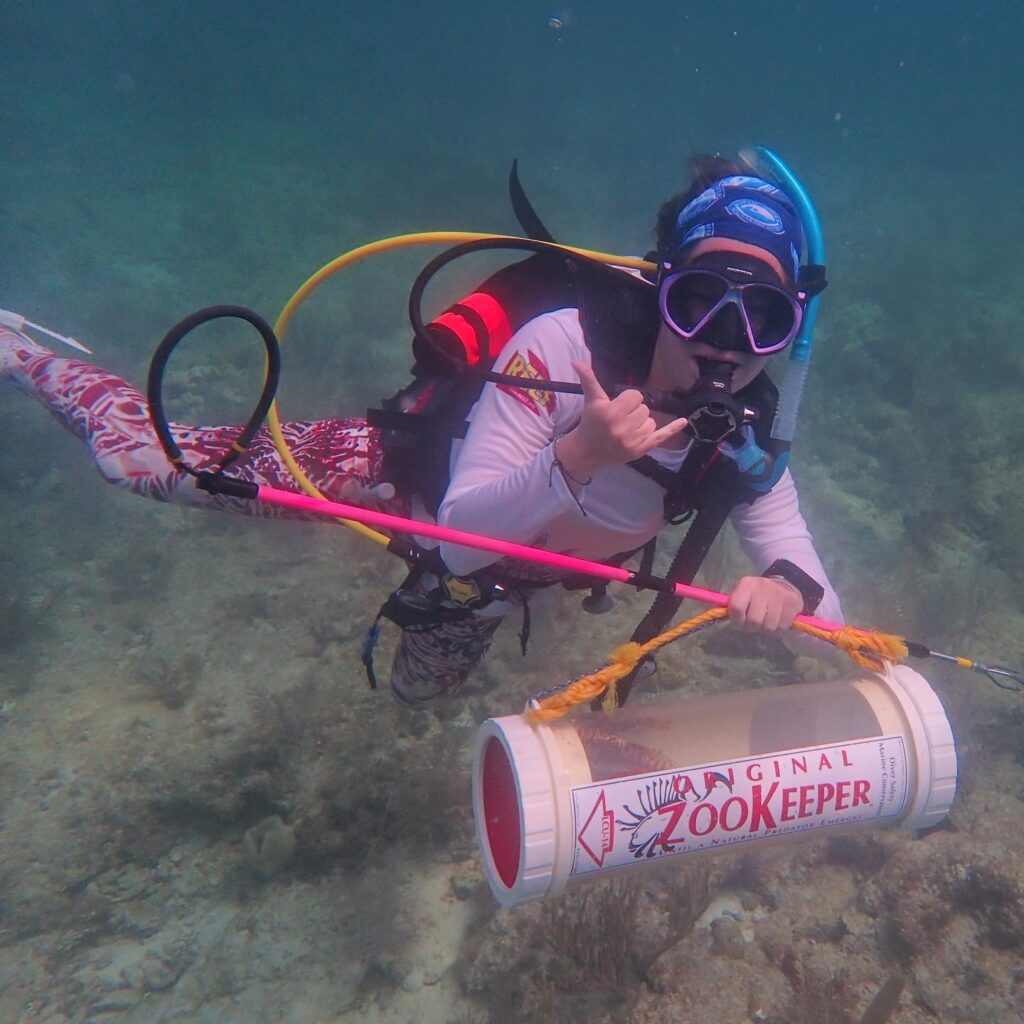 9 Diver with lionfish captured using Hawaiian sling.